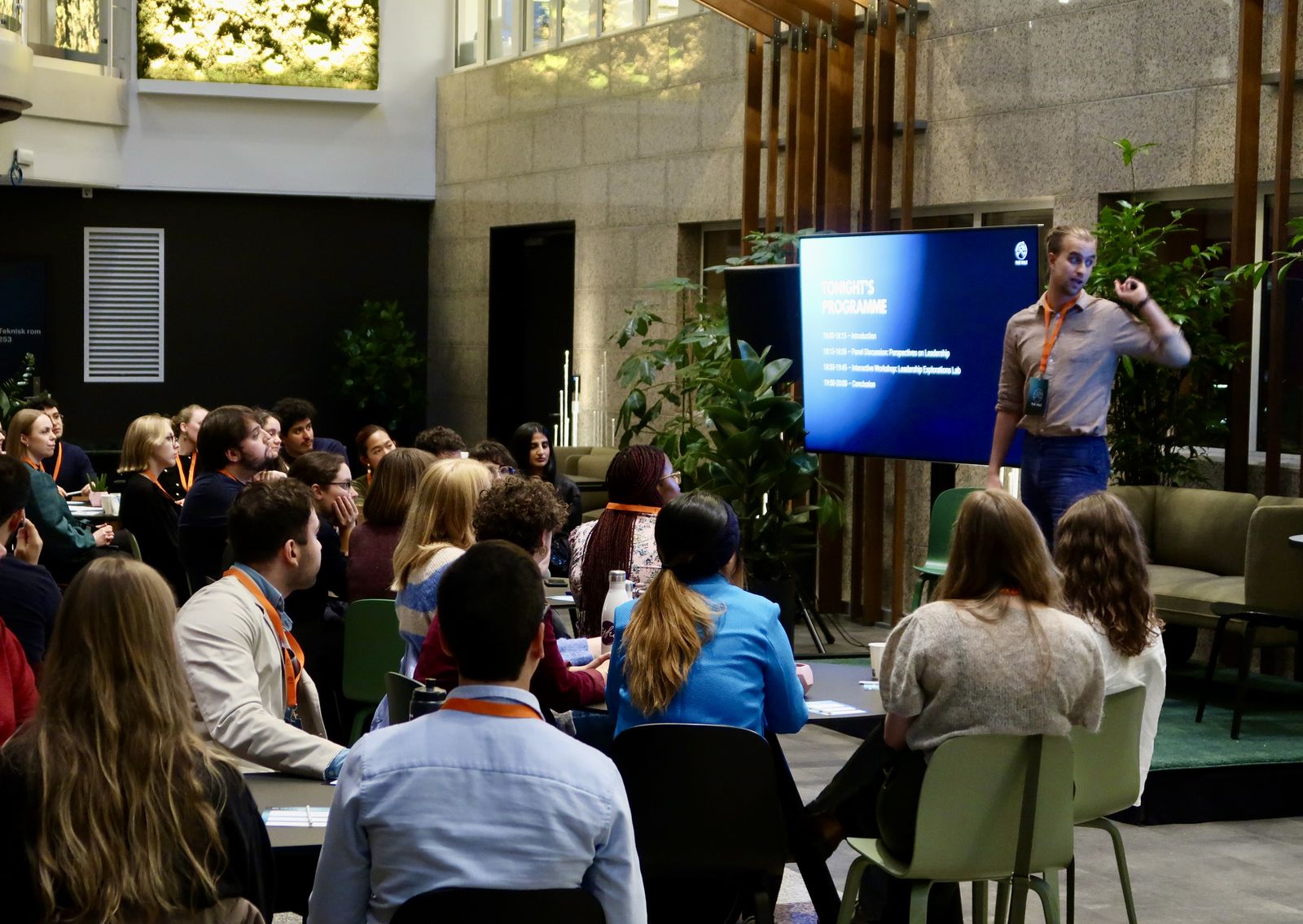 A speaker addressing a full audience at The VALE Symposium